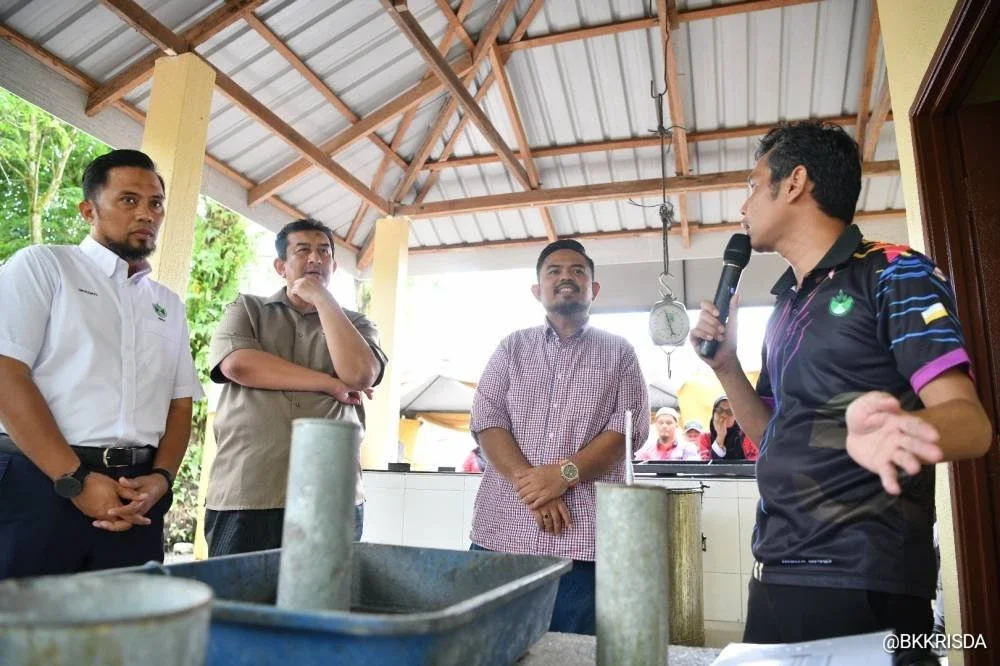 Manndzri (dua dari kanan) mendengar taklimat dan penerangan mengenai pengurusan Depo Pengumpulan Lateks (DPL) daripada pegawai RISDA Batang Padang/Perak Hilir.