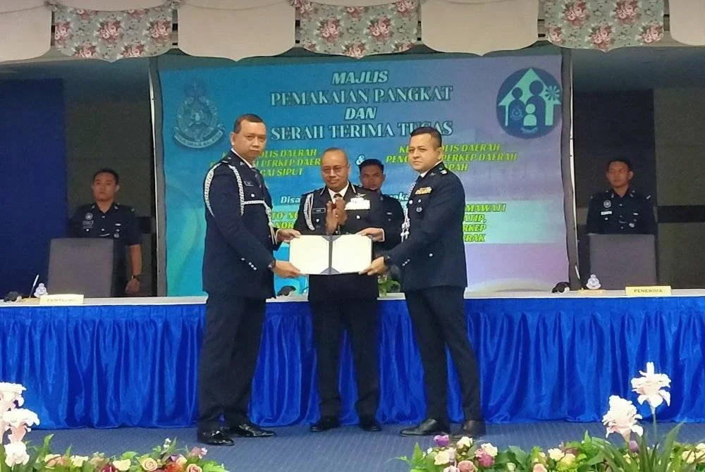 Noor Hisam (tengah) menyaksikan majlis serah terima tugas di antara Mohd Fadzil (kiri dengan Johari di Mes Pegawai Kanan Polis Perak pada Isnin.