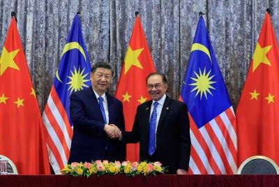 Perdana Menteri Datuk Seri Anwar Ibrahim (kanan) bersalaman dengan Presiden China Xi Jinping pada Majlis Menandatangani Memorandum Persefahaman (MoU) sempena Lawatan Negara Presiden China ke Malaysia di Kompleks Seri Perdana, pada Rabu. Foto Bernama