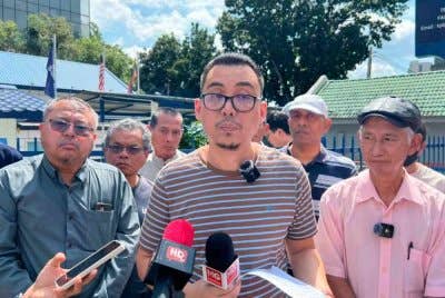 Rusnizam (tengah) ketika sidang akhbar selepas melakukan laporan di Balai Polis Tun Razak pada Jumaat.