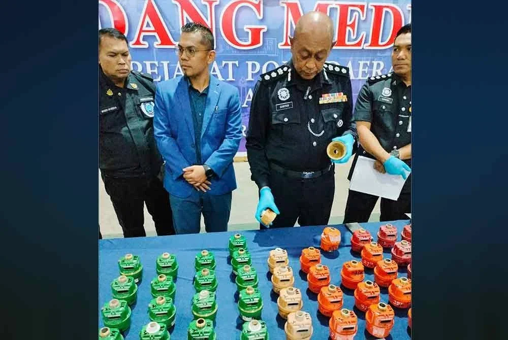 Hanyan (dua dari kanan) menunjukkan sarung meter air tembaga yang dirampas semasa sidang media pada Ahad.