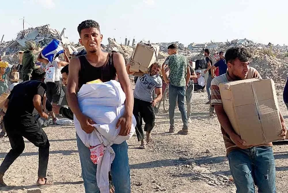 Beberapa pemuda Palestin yang berjaya mendapatkan kotak makanan untuk dibawa pulang kepada keluarga masing-masing.