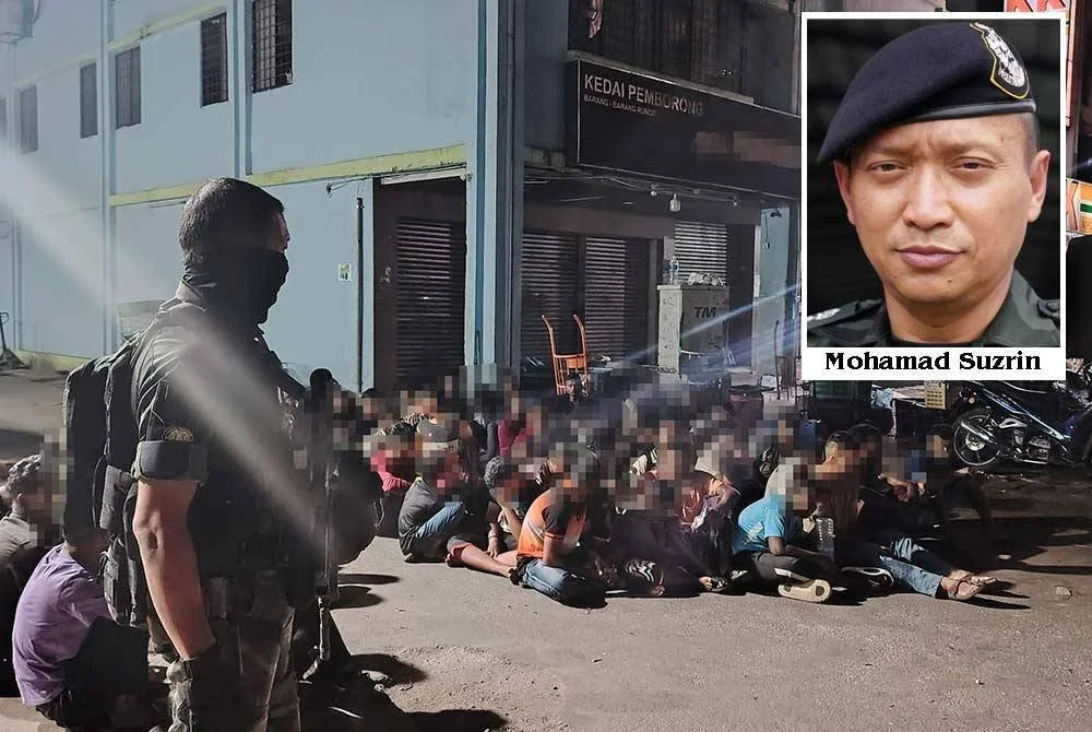 PGA mengawal lokasi serbuan bagi melaksanakan pemeriksaan warga asing di Selayang Utara, Kuala Lumpur pada Khamis.