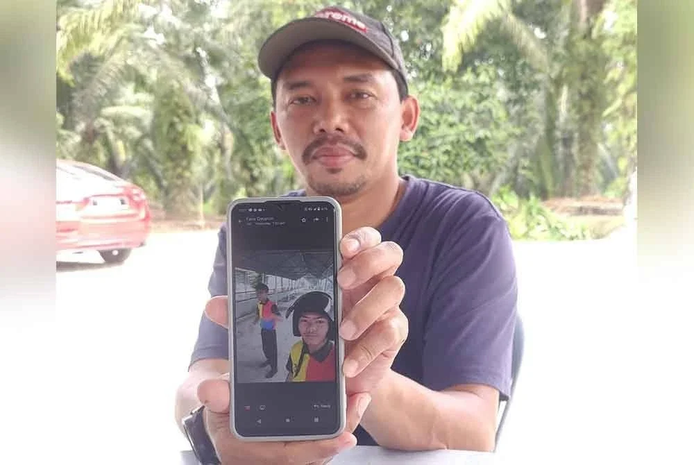 Mohd Fadzli menunjukkan gambar terakhir Allahyarham anaknya di sekolah sebelum maut dalam kemalangan di Jalan Parit Mahang, Jeram, di Kuala Selangor pada Khamis.