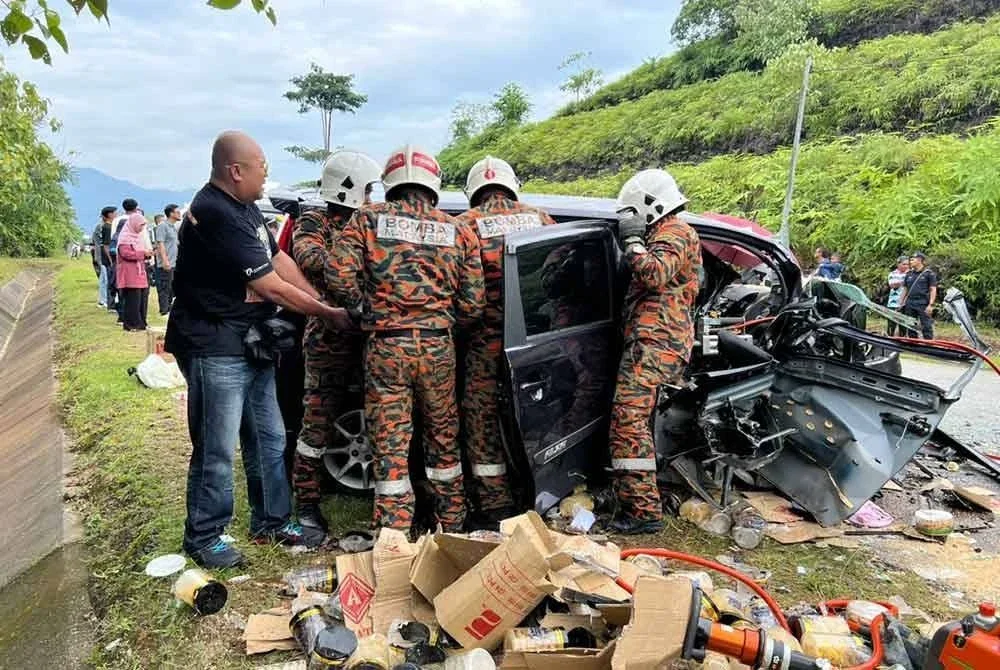 Pasukan bomba menjalankan operasi mengeluarkan mangsa yang tersepit dalam kenderaan. Foto ihsan Bomba Perak