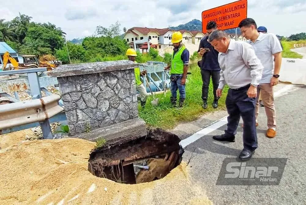Chon Siang melihat lubang besar yang muncul di laluan jambatan Sungai Galing, Jalan Beserah pada Ahad.