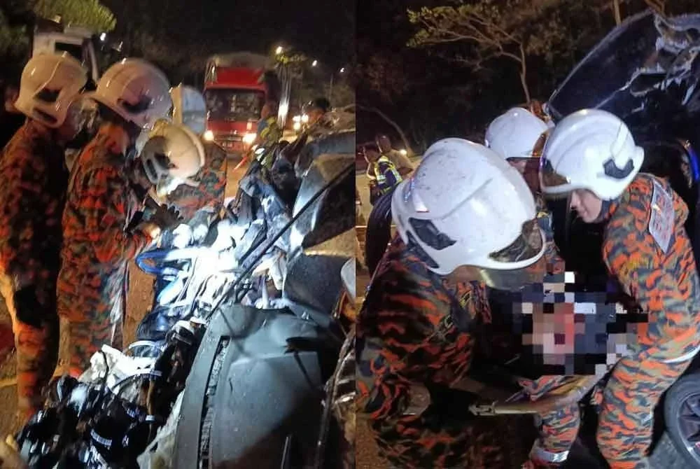 Anggota bomba membantu mengeluarkan mangsa yang tersepit. - Foto JBPM