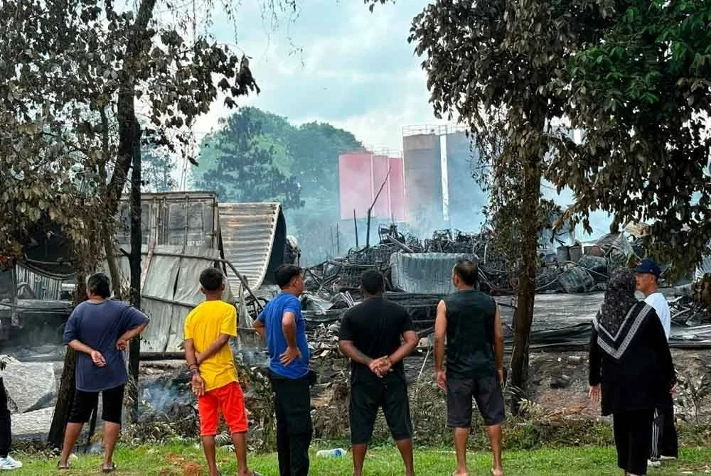 Orang ramai meninjau lokasi kejadian kebakaran stor penyimpanan lori dan minyak enjin di Jalan Cenderai, Taman Kota Puteri, Masai yang berlaku semalam ketika tinjauan pada Ahad. Foto Bernama