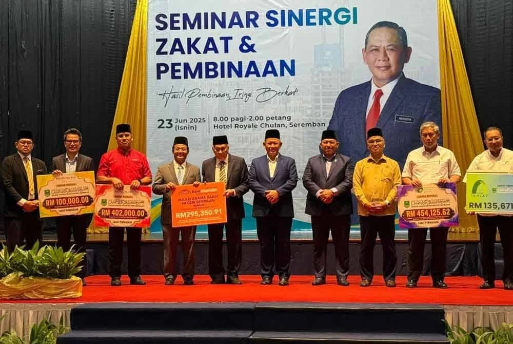 Aminuddin (lima dari kanan) bergambar bersama wakil syarikat yang membuat pembayaran zakat perniagaan pada Isnin.