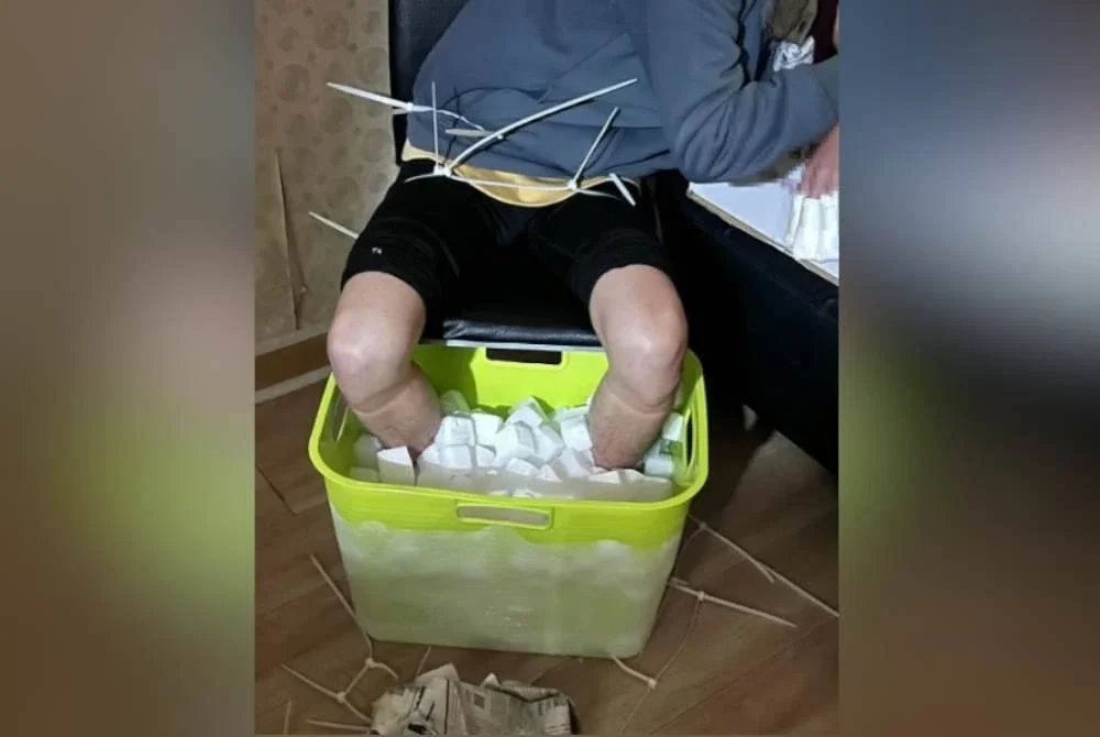 Zhang merendam kakinya yang tidak beralas ke dalam baldi berisi ais kering. Agensi