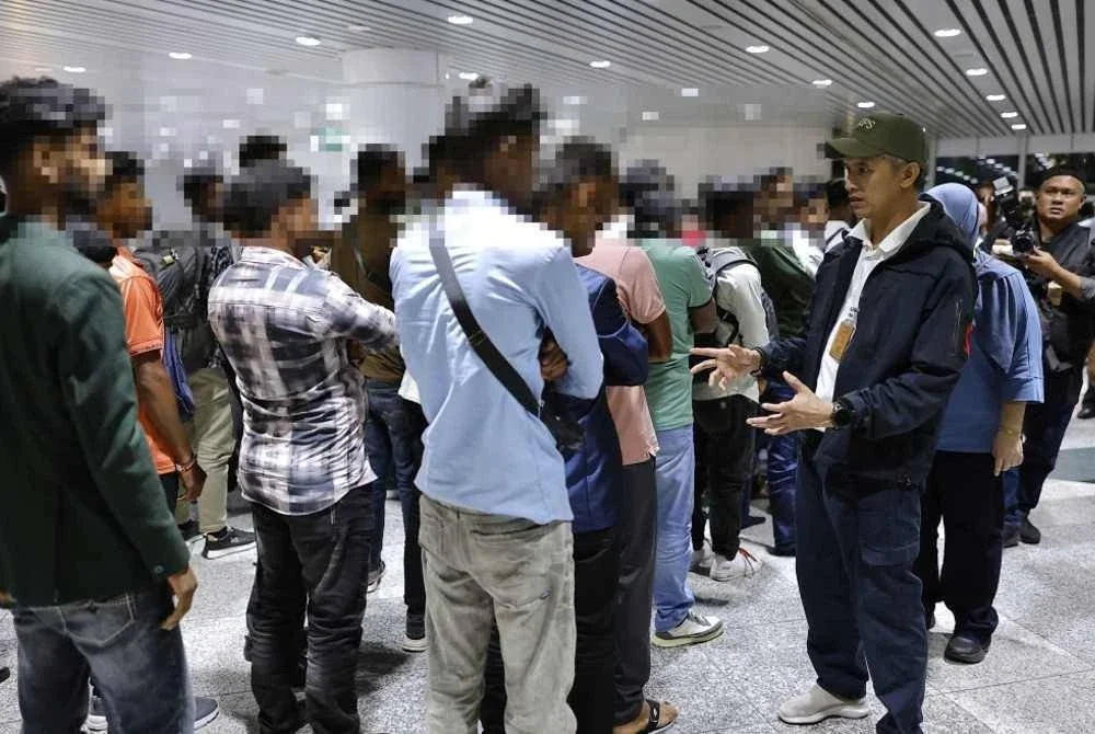 Mohd Shuhaily (kanan) bersama warga asing yang ditahan di KLIA pada Khamis. Foto Bernama