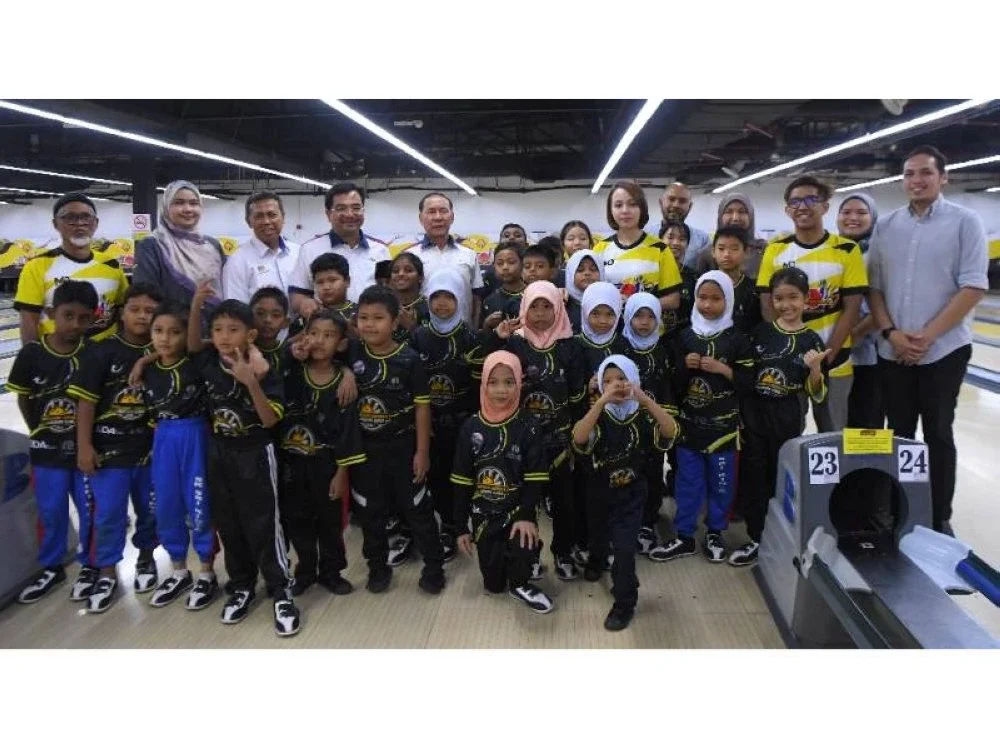 Mohd Annuar, (lima dari kiri) dan Johari Shukri (empat dari kiri) bersama wakil rakan strategik serta murid terpilih dari beberapa sekolah sempena Program UDA Cares: ‘Bangunkan Komuniti, Lahirkan Juara’ di sini pada Khamis. 