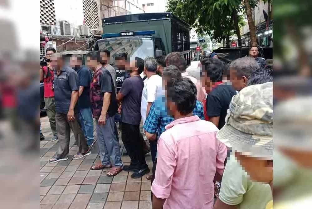 Antara warga asing yang ditahan untuk tindakan lanjut dalam operasi sekitar Jalan Masjid India, Kuala Lumpur pada Selasa.