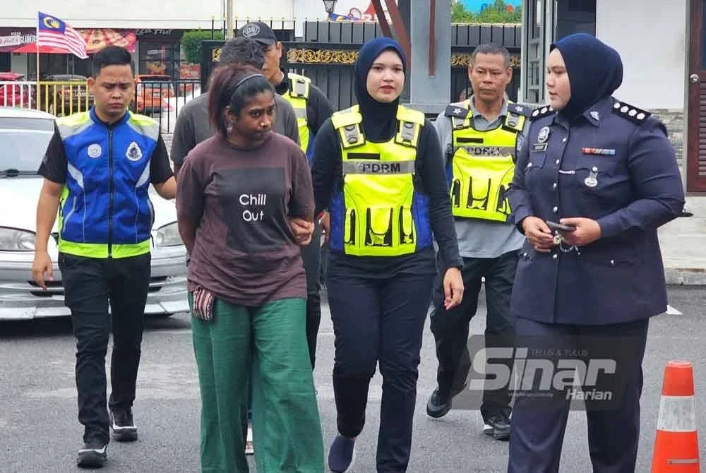 Shobna (dua dari kiri) tiba di Mahkamah Majistret Teluk Intan bagi pertuduhan membunuh ibu kepada kekasihnya.
