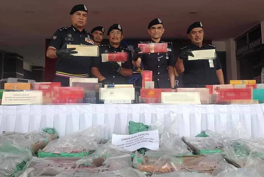 Shazeli (dua dari kanan) menunjukkan antara rampasan rokok yang dirampas polis pada 3 Ogos lalu.