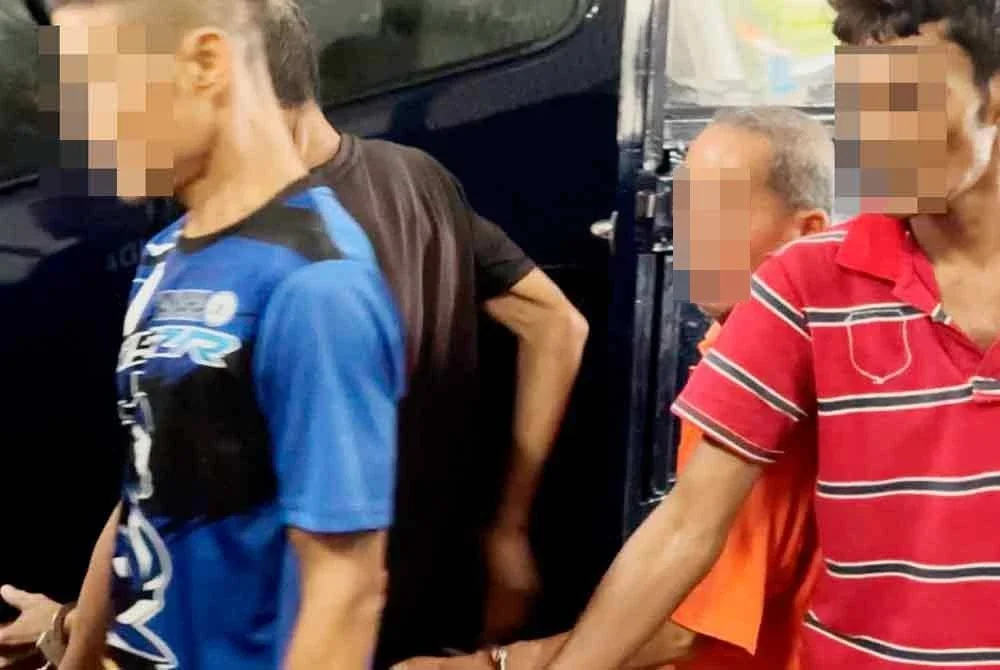 Tertuduh (baju oren) ketika dibawa ke Mahkamah Butterworth pada Jumaat.