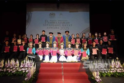 Profesor Dr Tan Awang Besar (berdiri, lapan dari kiri) dan Shaharuddin (berdiri, tengah) merakamkan gambar kenangan bersama graduan ASWARA dan mahasiswa Guangxi Arts University, di Panggung Eksprerimen ASWARA pada Sabtu. FOTO: ROSLI TALIB