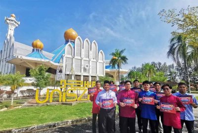 Mohd Ishaq (kiri) bersama pelajar UniSZA memegang plakad Malaysia #QuranHour yang akan diadakan di Masjid UniSZA sebagai lokasi perdana pada 30 Ogos ini.