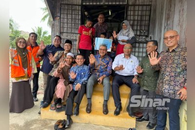 Wan Ahmad Dahlan (empat dari kanan) bersama-sama rombongan menunjukkan simbol Madani.