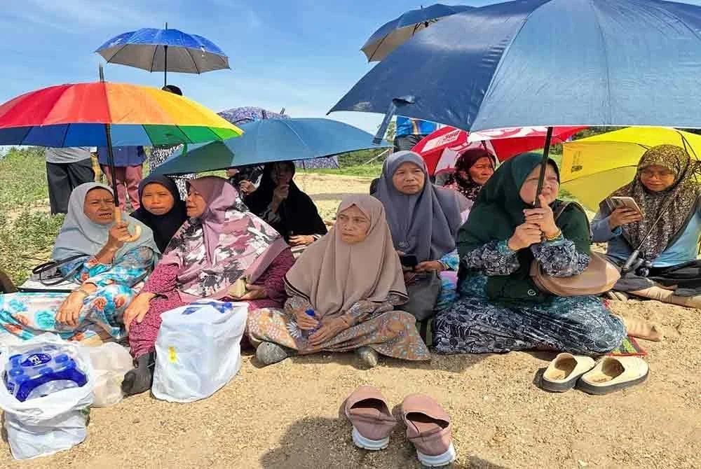 Ahli keluarga menunggu perkembangan operasi SAR mangsa di tepi Sungai Kelantan.