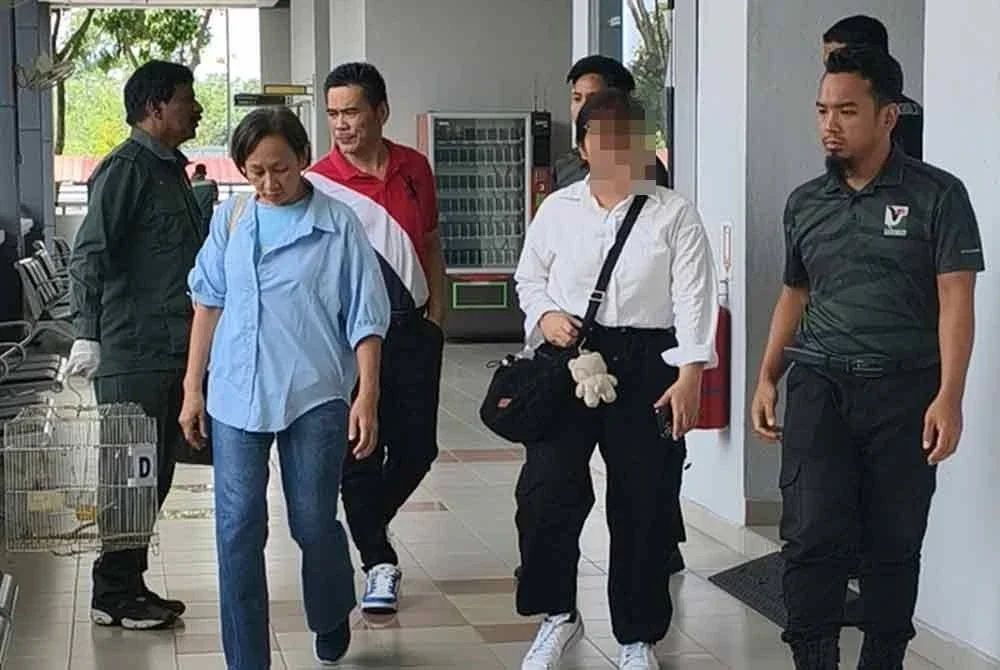 Gara-gara menyimpan daging babi bodoh tanpa permit khas, sepasang suami isteri, Thim Choy (belakang) dan Sui Ping (baju biru) didenda masing-masing RM6,000 oleh Mahkamah Sesyen pada Rabu.
