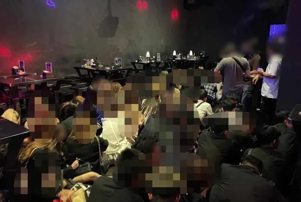 Antara individu diperiksa menerusi serbuan Jabatan Imigresen Malaysia di sebuah pusat hiburan pada Selasa.