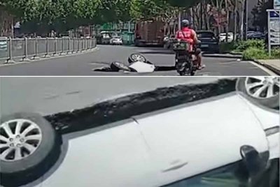 Sebuah SUV yang membawa empat penumpang terjunam ke dalam lubang benam yang tiba-tiba terbentuk di Hefei, China. Foto Agensi