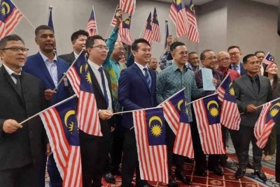Steven bersama wakil NGO yang terlibat dalam ekonomi gig mengibarkan Jalur Gemilang pada sidang akhbar selepas RUU Pekerja Gig diluluskan di Dewan Rakyat pada petang Khamis.
