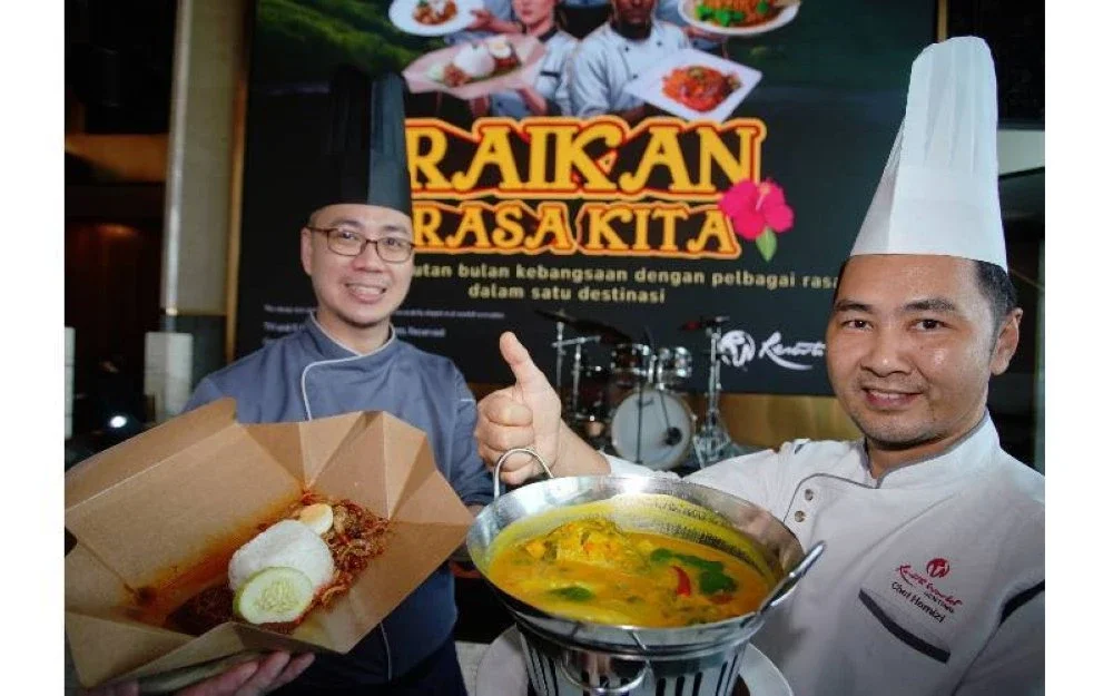 Cef Hans Lim Yi Han (kiri) menunjukkan Nasi Lemak dan cef Norhamizi (kanan) menunjukkan Patin Tempoyak pada pelancaran Raikan Rasa Kita yang diadakan di Park Avenue Lounge, Skyavenue, Resorts World Genting, pada Khamis.