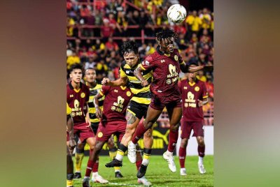 Pemain Negeri Sembilan, Alexander Agyakwa (kanan) cuba menanduk bola ketika menentang Kuching City dalam aksi Liga Super di Stadium Tuanku Abdul Rahman, Paroi pada Jumaat.