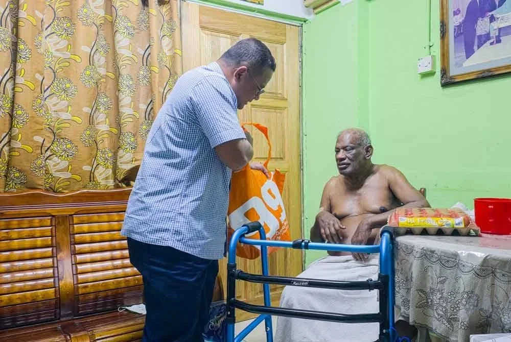 Amirudin menyerahkan barangan keperluan asas yang dibeli menerusi bantuan SARA kepada golongan memerlukan. Foto Facebook Nurul Izzah