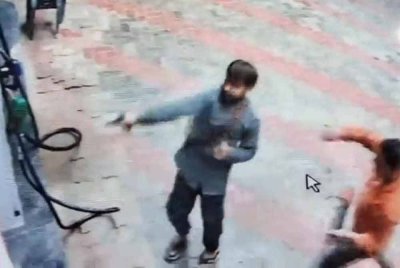 Tangkap layar rakaman CCTV menunjukkan dua lelaki melepaskan tembakan di sebuah stesen minyak di Madhya Pradesh, India selepas pekerja enggan mengisi petrol motosikal mereka.