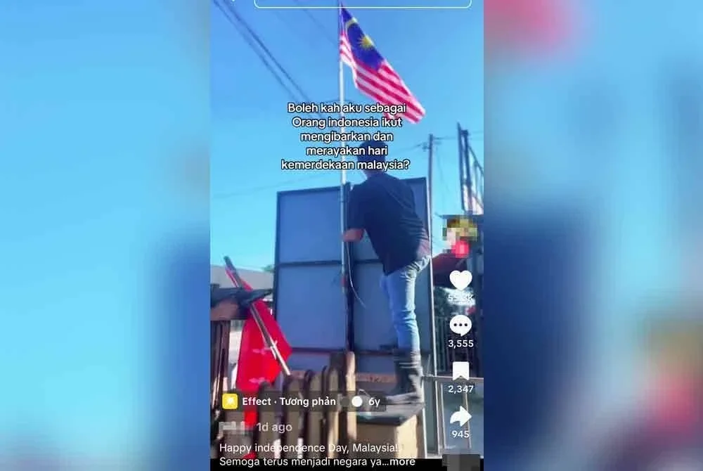 Pengguna TikTok Nijarrslsaa memaparkan seorang lelaki berdiri di atas tembok pagar sambil mengikat Jalur Gemilang.