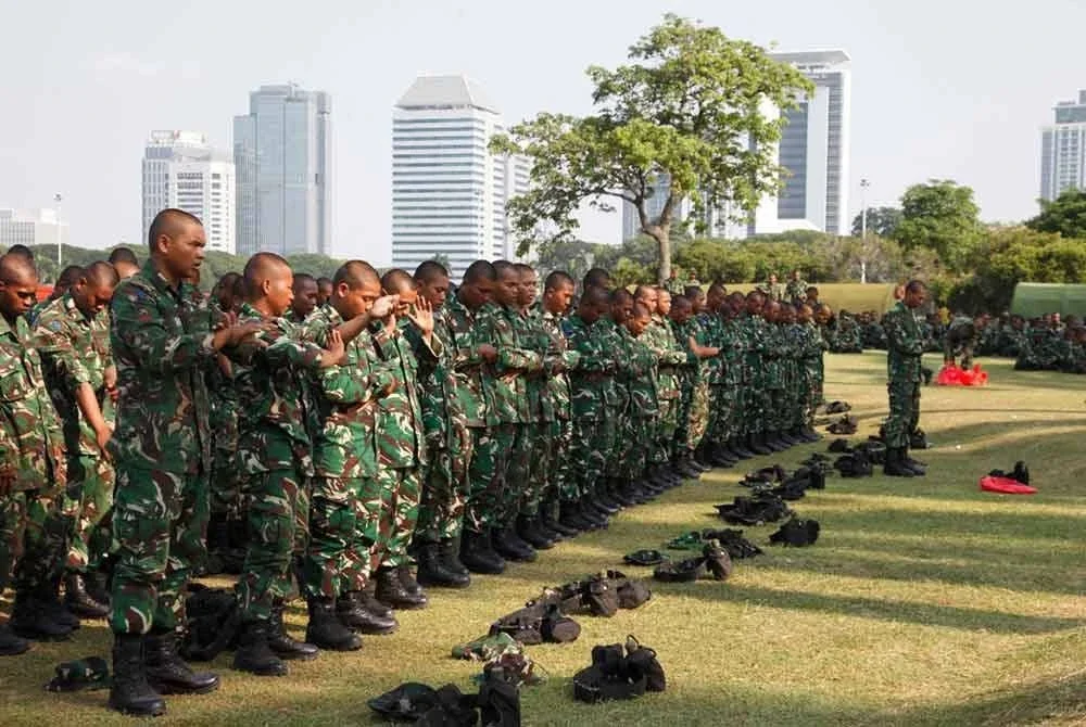 Anggota TNI kelihatan menunaikan solat di Medan Merdeka, Jakarta pada isnin. - Foto: AFP