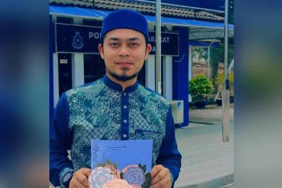 Hafez menunjukkan laporan polis yang dibuat di Balai Polis Tambun berhubung penyebaran tangkap layar berkenaan.