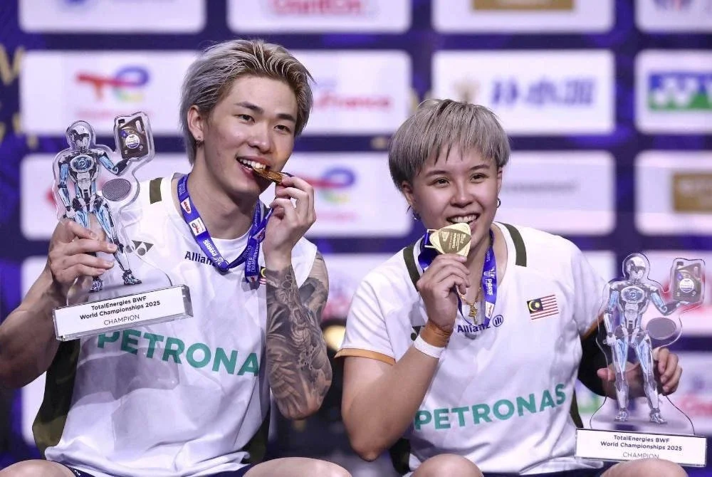 Tang Jie (kiri) dan Ee Wei muncul beregu campuran pertama negara bergelar juara dunia. Foto Agensi