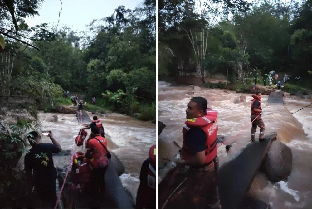 Anggota Bomba menyelamatkan mangsa terperangkap di seberang sungai akibat kepala air di sini pada Khamis.
