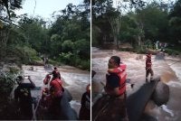 Anggota Bomba menyelamatkan mangsa terperangkap di seberang sungai akibat kepala air di sini pada Khamis.