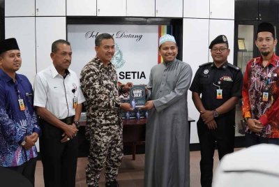 Amar Mirza (tiga dari kanan) menyampaikan sebanyak 500 naskhah buku agama kepada pihak Penjara Pengkalan Chepa.