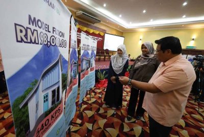 Kamarul Rashdan (kanan) menunjukkan pilihan rumah di bawah inisiatif Rumah Ibu.
