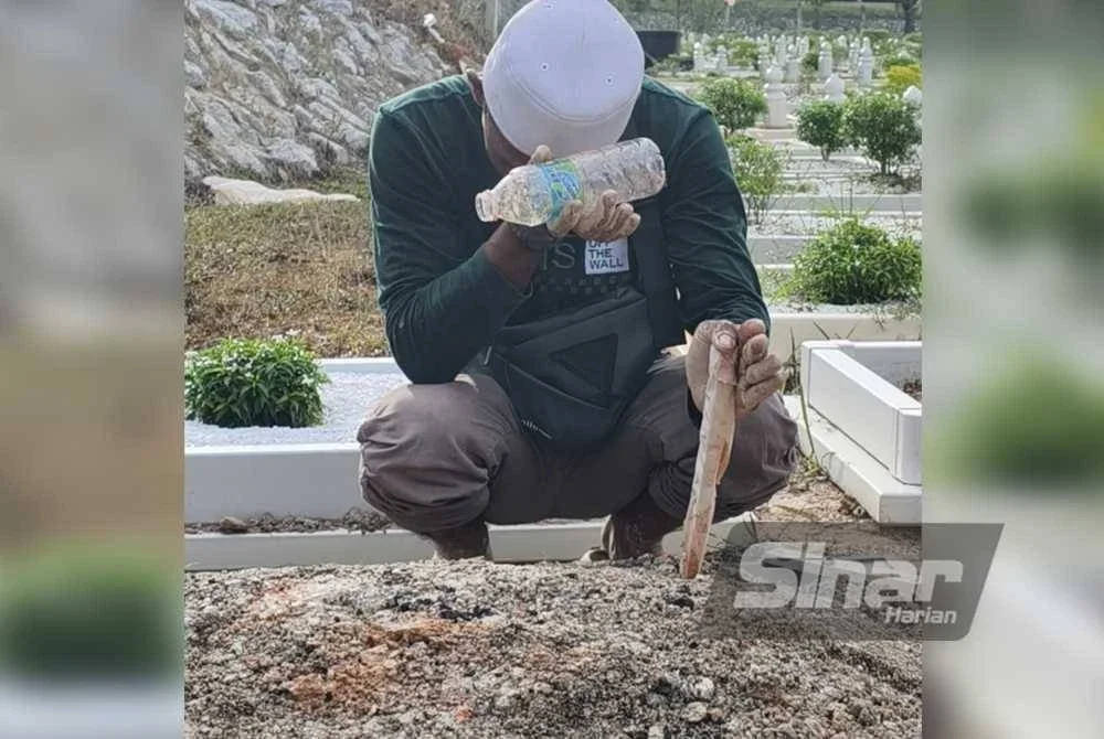 Ade menangis di pusara kanak-kanak yang meninggal dunia akibat lemas.