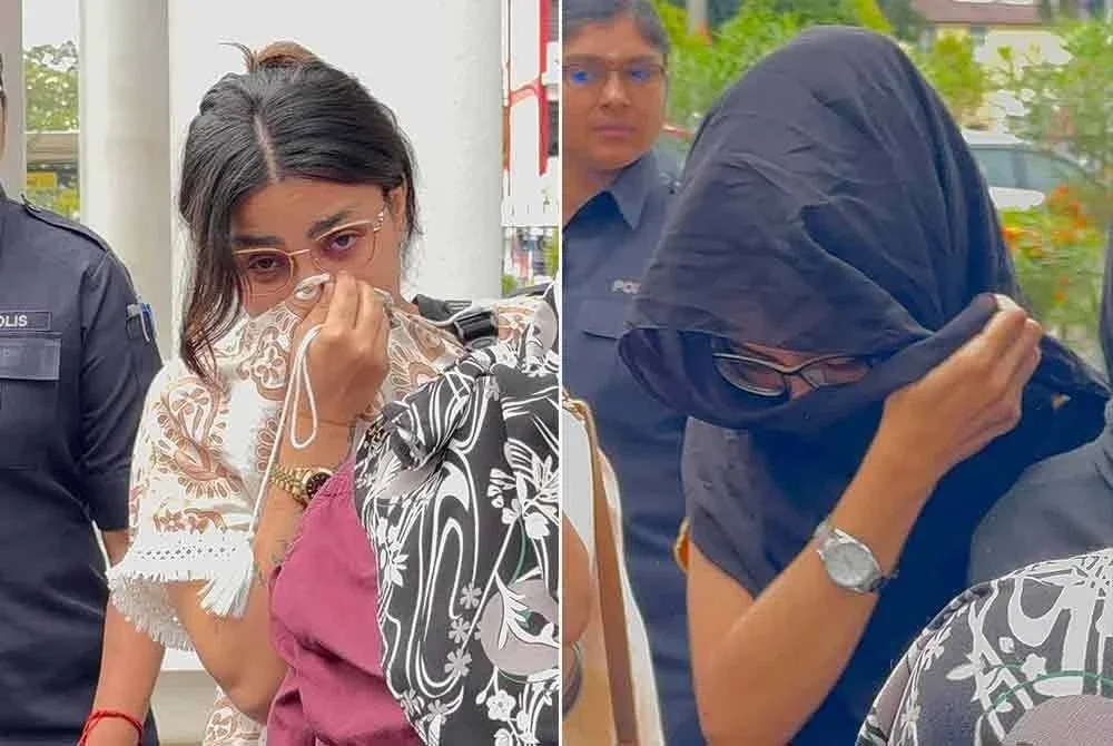 Sara (kiri) dan Zahra tiba di Mahkamah George Town sambil diiringi pegawai polis pada Rabu.