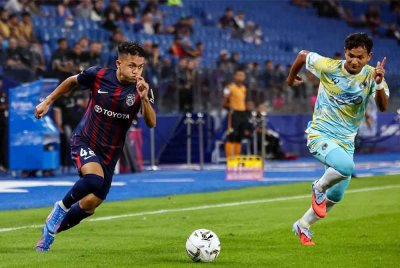 Pemain JDT, Arif Aiman Mohd Hanapi (kiri) melepasi kawalan pemain Penang FC Ahmad Irfan Mohd Noor (kanan) pada perlawanan Liga Super Malaysia 25/26 di Stadium Sultan Ibrahim, pada Khamis. Foto Bernama