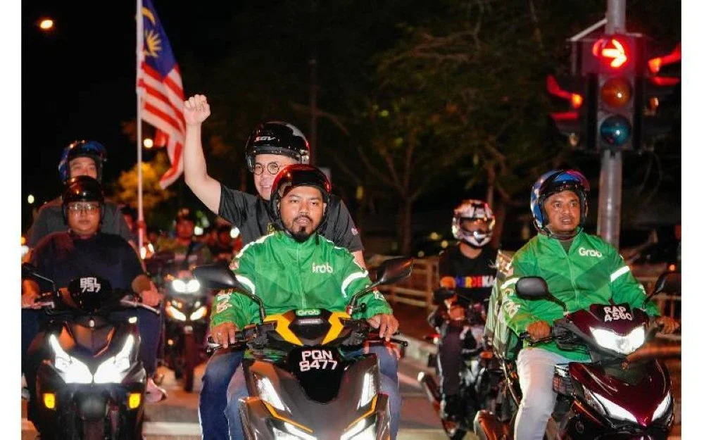 Steven Sim turun padang bersama penunggang motosikal e-hailing.