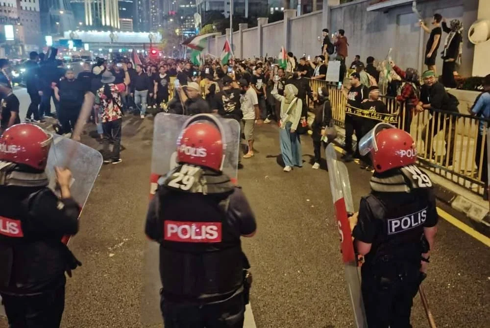 Peserta berarak sejauh kira-kira 300 meter ke Kedutaan AS dengan mengibarkan bendera Palestin.