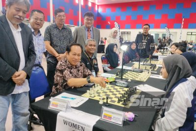 Ahmad (duduk, kiri) merasmikan Kejohanan Catur Peringkat Kebangsaan Interstates di Dewan Muafakat Taman Saujana, Pontian.