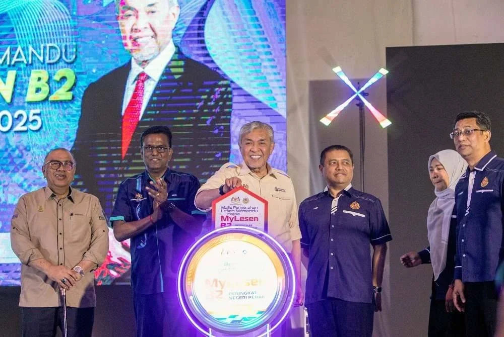 Ahmad Zahid (tiga dari kiri) menyempurnakan gimik perasmian pada Majlis Penyerahan Lesen Memandu Program MyLesen B2 Peringkat Negeri Perak Tahun 2025 di Kompleks UMNO Bagan Datuk hari ini. Foto Bernama