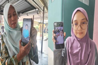 Nor Aziera (kanan) dan Farizon menunjukkan gambar anak mereka yang maut dalam kemalangan di Jalan Bukit Keluang Besut pada Selasa.