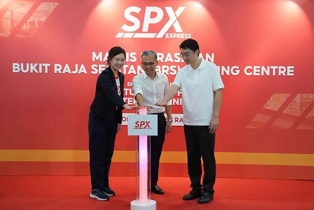 Fahmi bersama Junjie (kanan) dan Lee Sun menekan butang sebagai gimik perasmian Pusat Pengumpulan dan Pengasingan SPX Express Bukit Raja Selatan pada Rabu. FOTO: SINAR HARIAN/ROSLI TALIB
