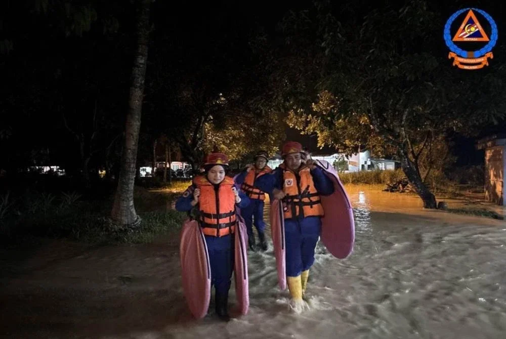 Anggota APM Kulim membuat persiapan untuk membuka PPS di daerah tersebut yang dilanda banjir pada malam Khamis. Foto APM